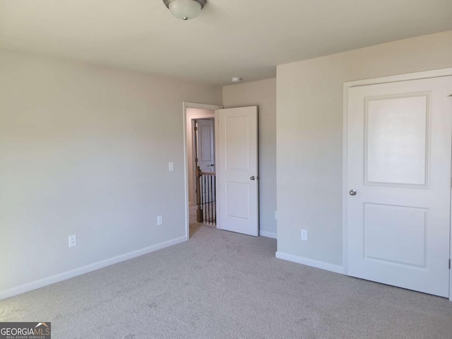 unfurnished bedroom with light carpet