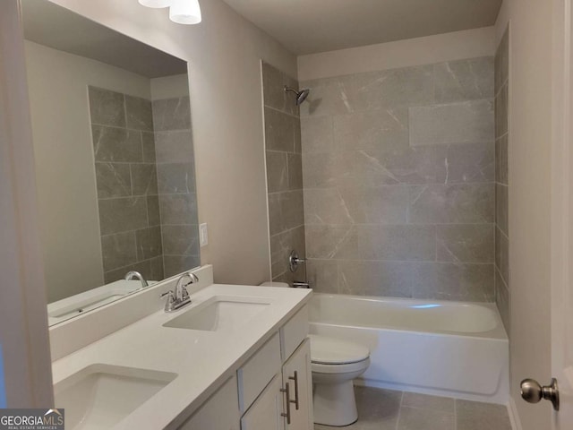 full bathroom featuring vanity, tile patterned floors, toilet, and tiled shower / bath