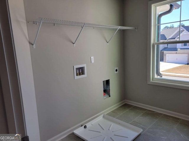 clothes washing area featuring electric dryer hookup, hookup for a washing machine, and a wealth of natural light