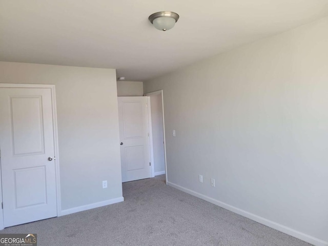 unfurnished bedroom featuring light colored carpet