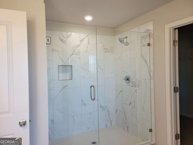 bathroom with a shower with shower door