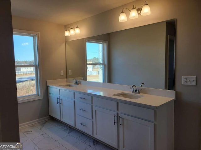 bathroom featuring a healthy amount of sunlight and vanity