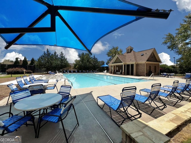 view of swimming pool with a patio area