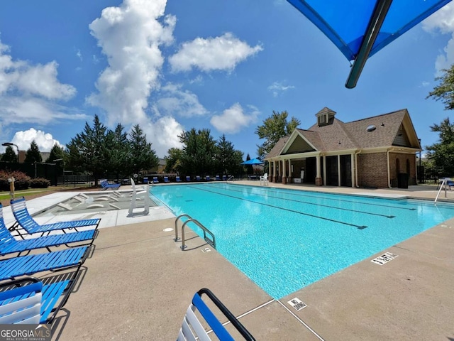 view of swimming pool with a patio