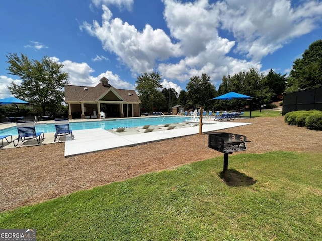 view of pool featuring a yard and a patio area