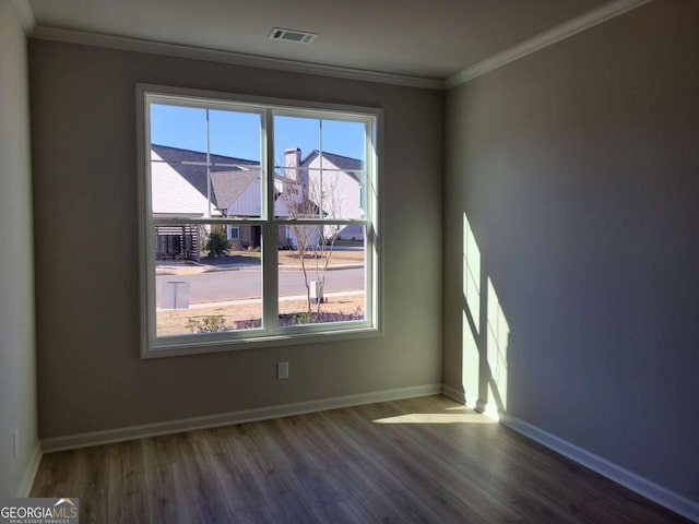 unfurnished room with ornamental molding and dark hardwood / wood-style floors