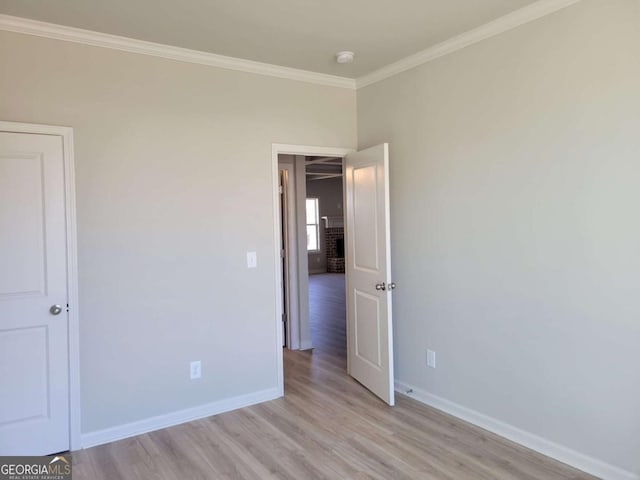 unfurnished bedroom with crown molding and light hardwood / wood-style flooring