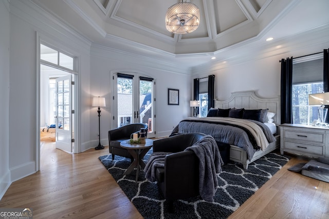 bedroom with access to exterior, a high ceiling, ornamental molding, french doors, and light wood-type flooring