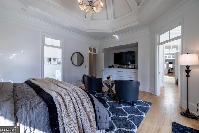 bedroom with crown molding, a towering ceiling, and light hardwood / wood-style floors