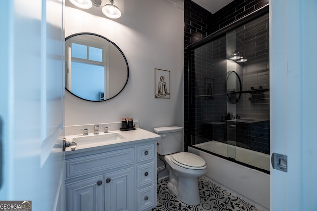 full bathroom featuring vanity, bath / shower combo with glass door, and toilet