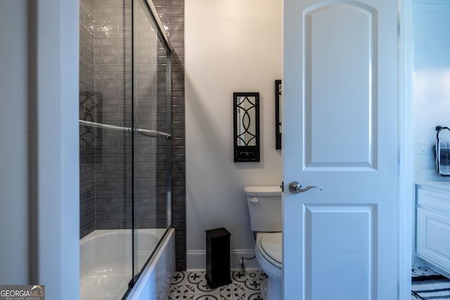 bathroom with shower / bath combination with glass door, toilet, and tile patterned flooring