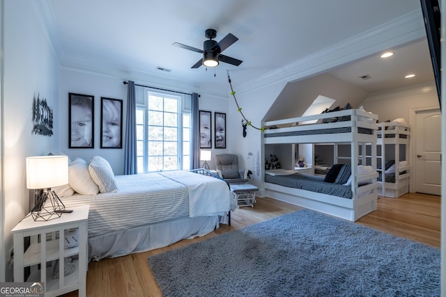 bedroom with ornamental molding and light hardwood / wood-style flooring