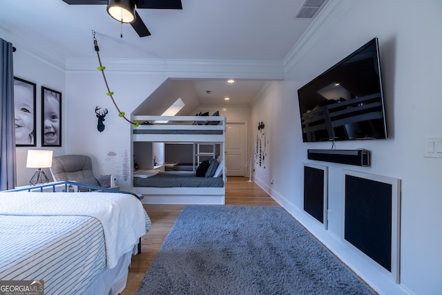 bedroom featuring hardwood / wood-style floors and crown molding