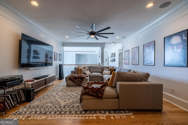 living room featuring hardwood / wood-style flooring, ornamental molding, decorative columns, and ceiling fan