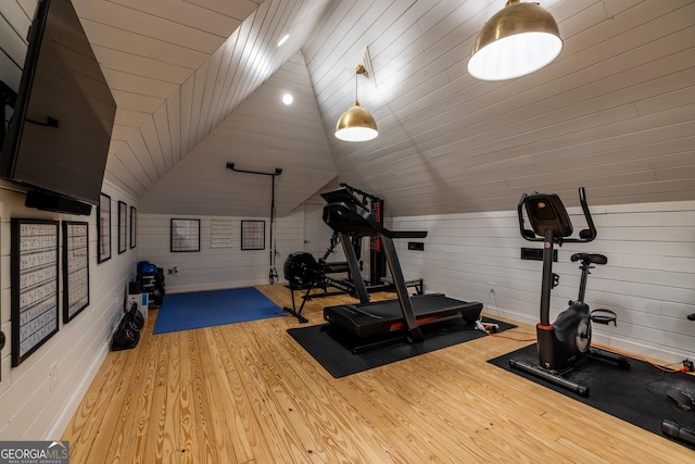 exercise area with lofted ceiling and light hardwood / wood-style flooring