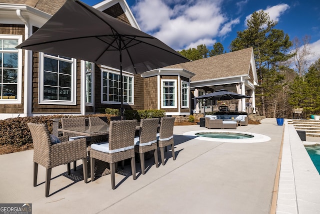 view of patio / terrace featuring an outdoor living space and a jacuzzi