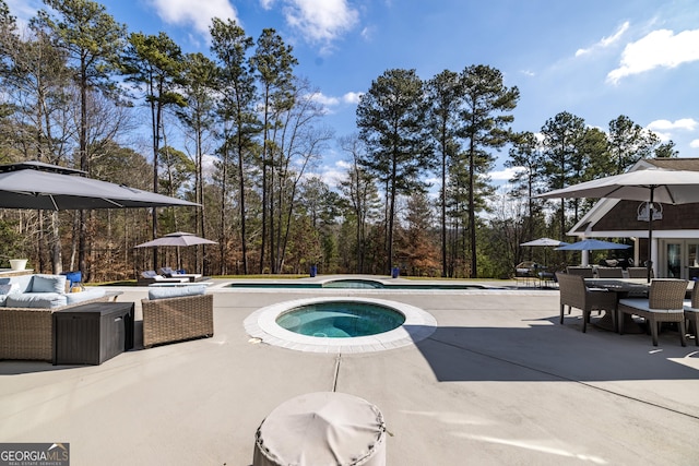 view of pool featuring a patio area, outdoor lounge area, and an in ground hot tub