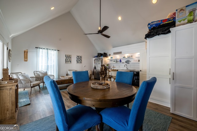 dining room with ceiling fan, sink, dark hardwood / wood-style flooring, and high vaulted ceiling