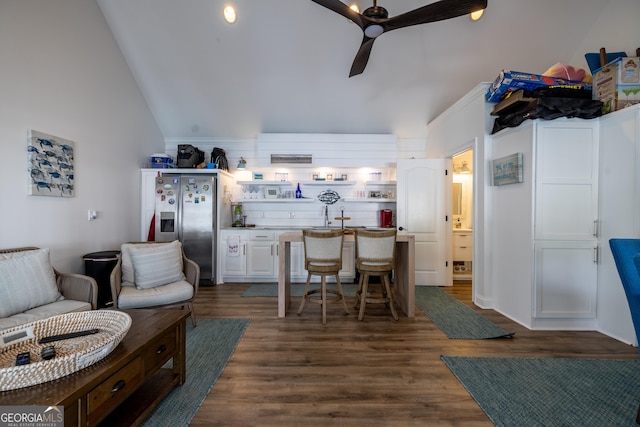 kitchen with white cabinets, dark hardwood / wood-style flooring, stainless steel fridge, and ceiling fan