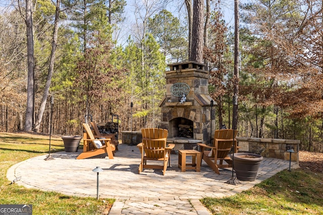 view of patio with an outdoor stone fireplace