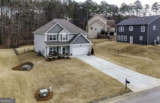 view of front of home with cooling unit, covered porch, and a front lawn