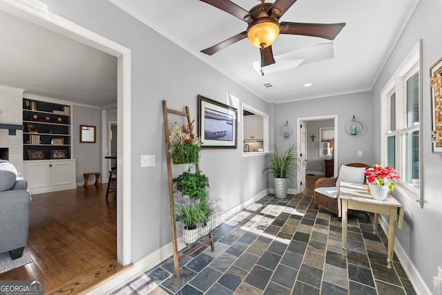 living area with crown molding, ceiling fan, and dark hardwood / wood-style floors