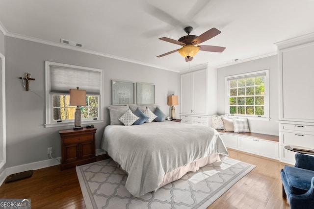 bedroom with crown molding, ceiling fan, and hardwood / wood-style floors