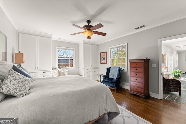 bedroom featuring dark wood-type flooring, ceiling fan, and ornamental molding