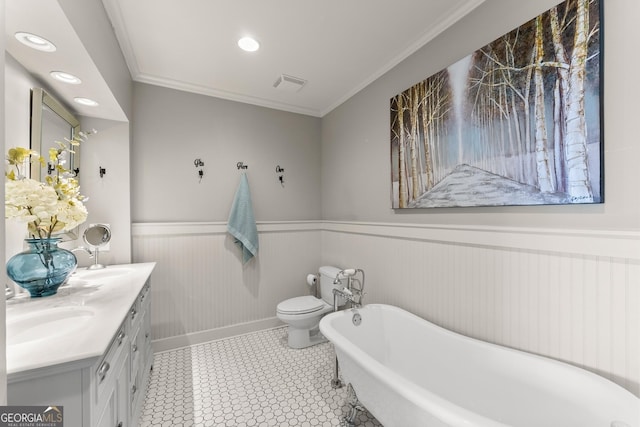 bathroom with toilet, crown molding, vanity, a tub, and tile patterned flooring