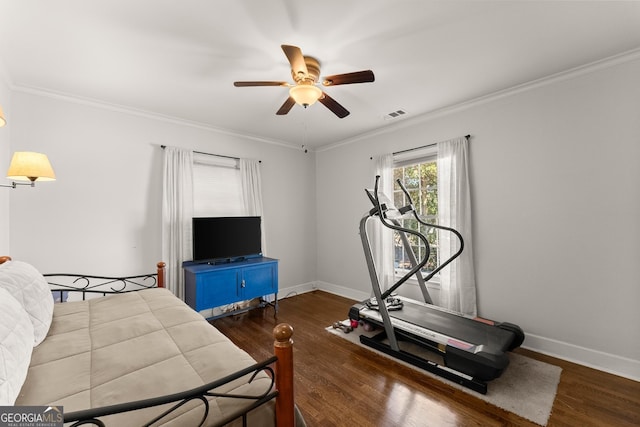 workout area featuring crown molding, ceiling fan, and dark hardwood / wood-style flooring