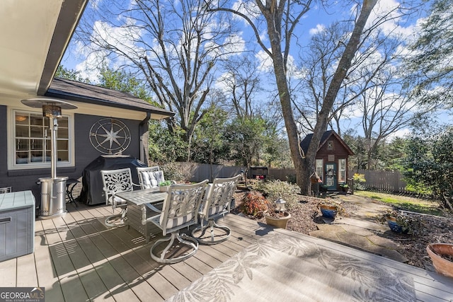 wooden terrace featuring an outbuilding and grilling area