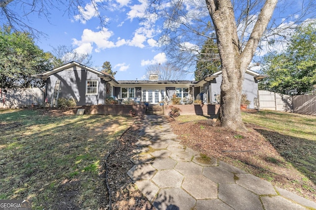 view of front of home with covered porch and a front yard