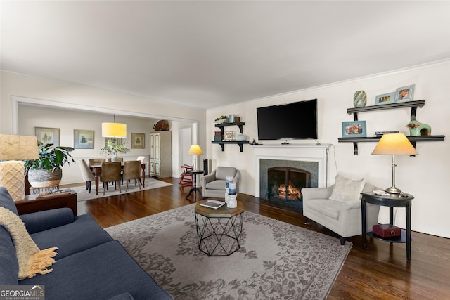 living room with crown molding and hardwood / wood-style floors