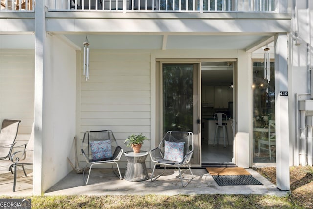 entrance to property with a balcony and a patio area