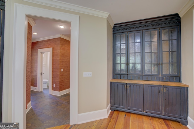 foyer entrance featuring ornamental molding and hardwood / wood-style floors