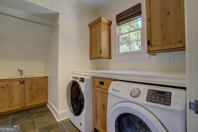 laundry room with cabinets, ornamental molding, separate washer and dryer, and sink