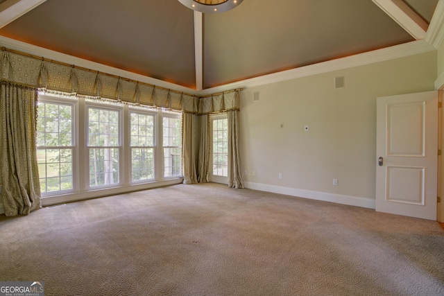 empty room featuring light colored carpet, ornamental molding, and a towering ceiling