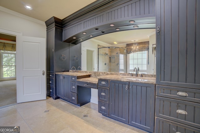 bathroom with ornamental molding, a healthy amount of sunlight, vanity, and a shower with shower door