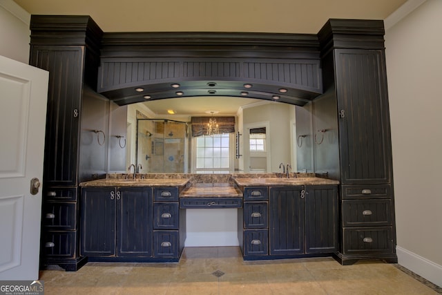 bathroom with tile patterned flooring, vanity, a notable chandelier, and walk in shower