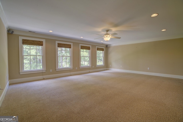 spare room with light carpet, crown molding, and ceiling fan