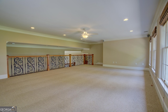 carpeted spare room featuring ornamental molding and ceiling fan