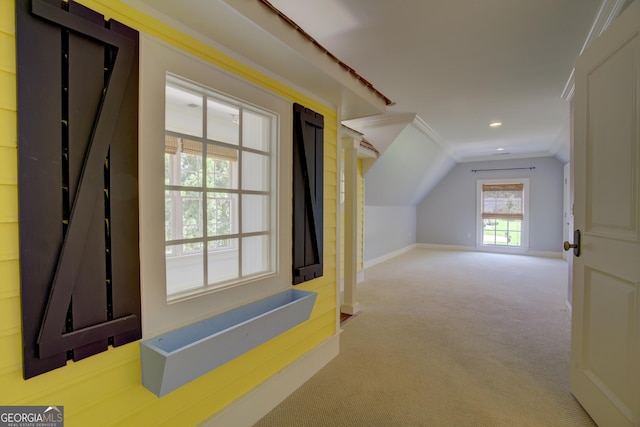 bonus room featuring vaulted ceiling and light colored carpet