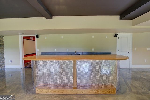 kitchen featuring wood counters and beamed ceiling