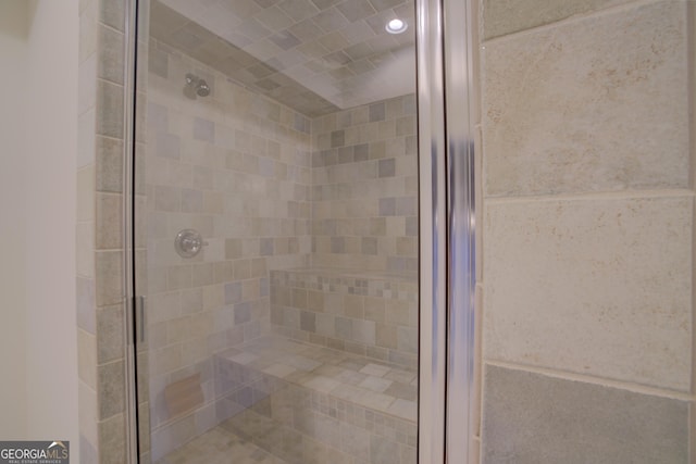 bathroom with a shower with door