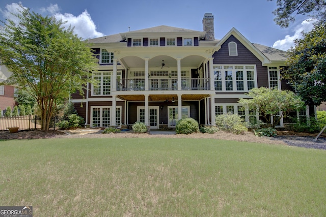 back of house featuring french doors and a yard