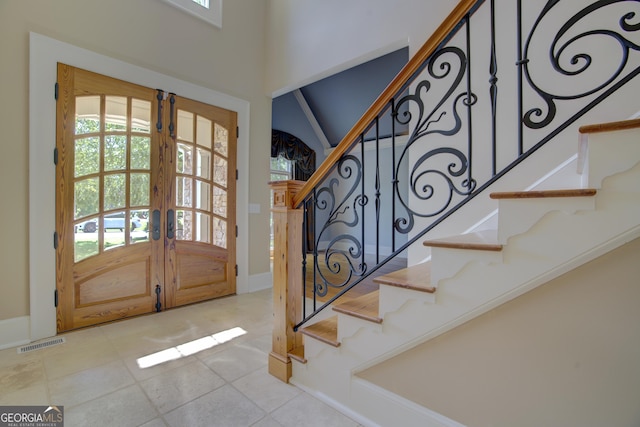 tiled entryway featuring a wealth of natural light and french doors