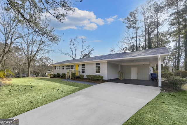 ranch-style house featuring a front yard, brick siding, driveway, and an attached carport