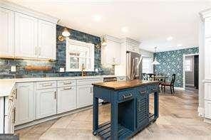 kitchen with a center island, sink, and white cabinets