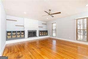 unfurnished living room with wood-type flooring