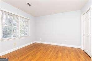 spare room featuring wood-type flooring